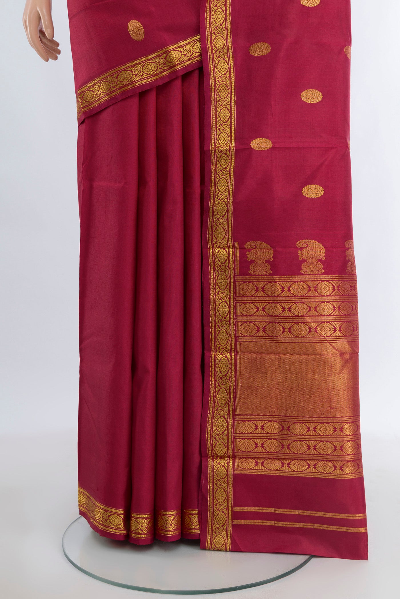 Pleats and pallu of Maroon Kanjivaram Silk Saree with Zari Butta on the body and Zari Border. 