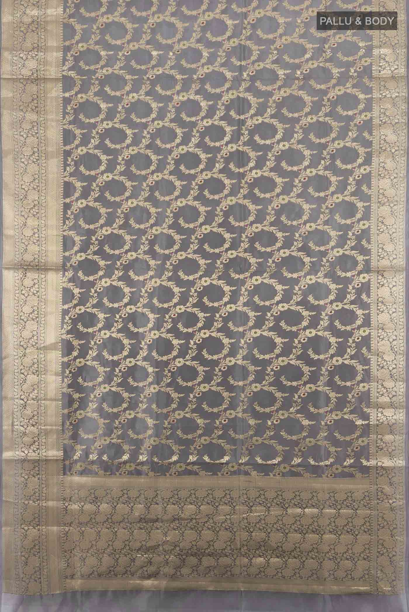 Flat view of Grey Banarasi Raw Silk Saree with Zari Butta on the body and Silk Border. 