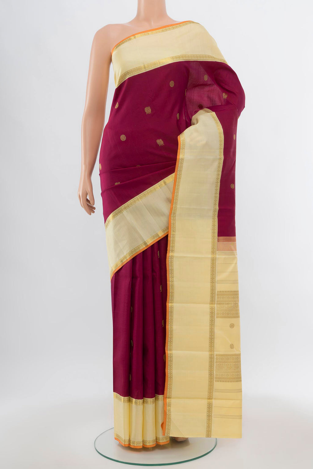 Pure Silk Pure Zari Maroon Kanchipuram Saree with Zari Butta on the body and Silk Border.  displayed on a mannequin