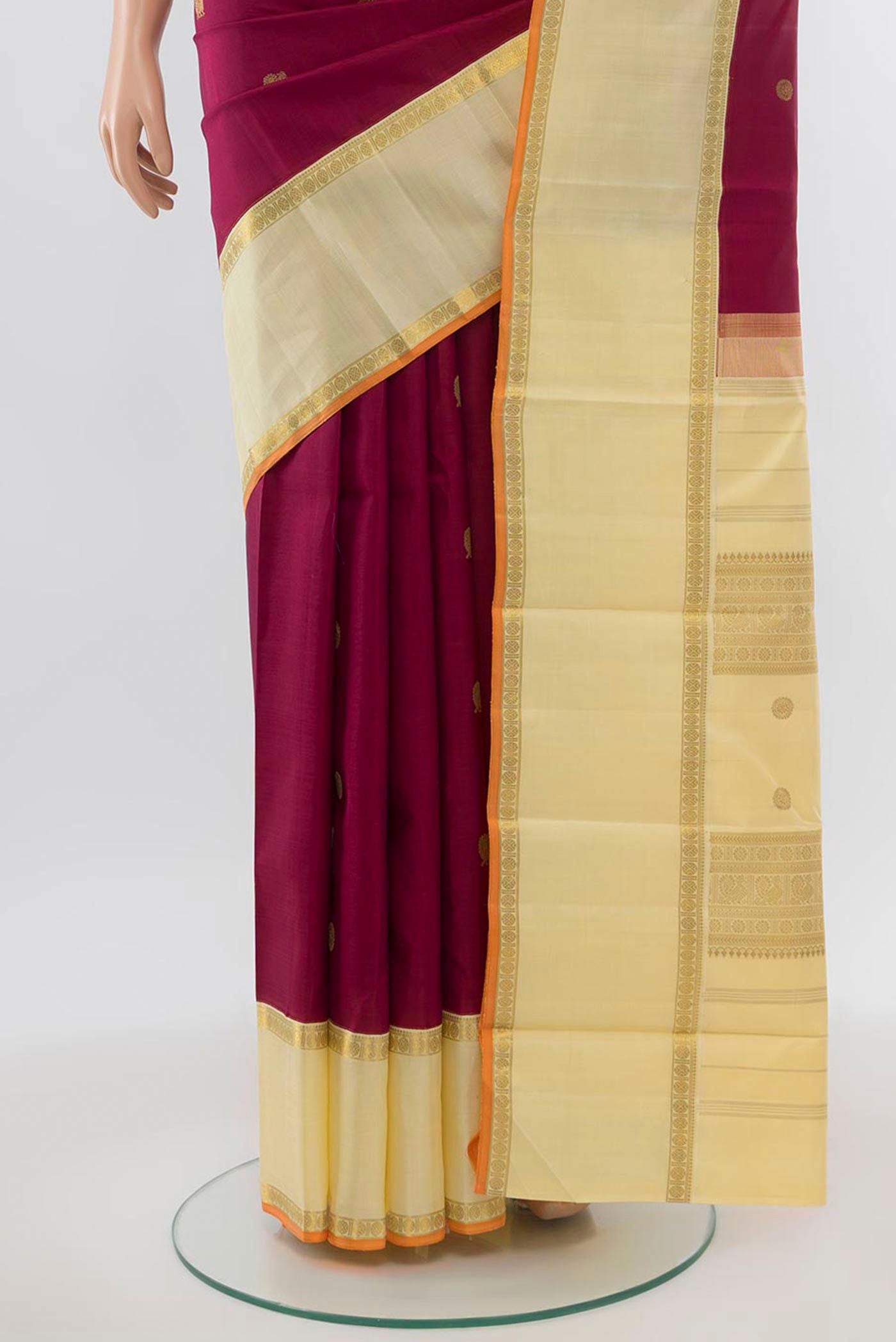 Pleats and pallu of Pure Silk Pure Zari Maroon Kanchipuram Saree with Zari Butta on the body and Silk Border. 