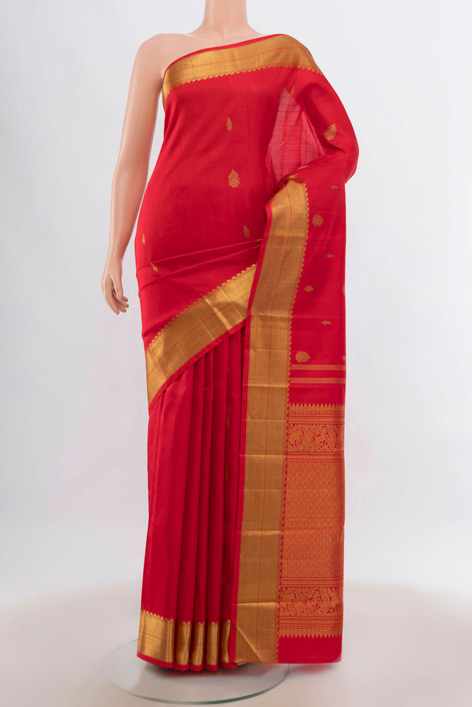Red Kanjivaram Silk Saree with Zari Butta on the body and Silk Border.  displayed on a mannequin