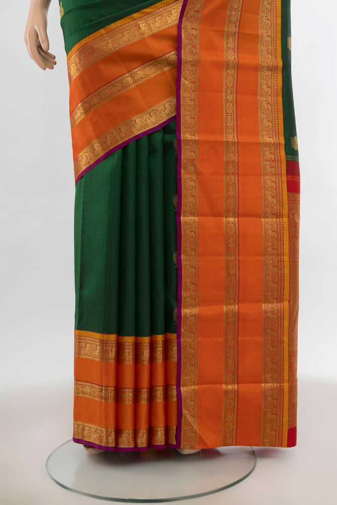 Pleats and pallu of Bottle Green Kanjivaram Silk Saree with Zari Butta on the body and Silk Border. 