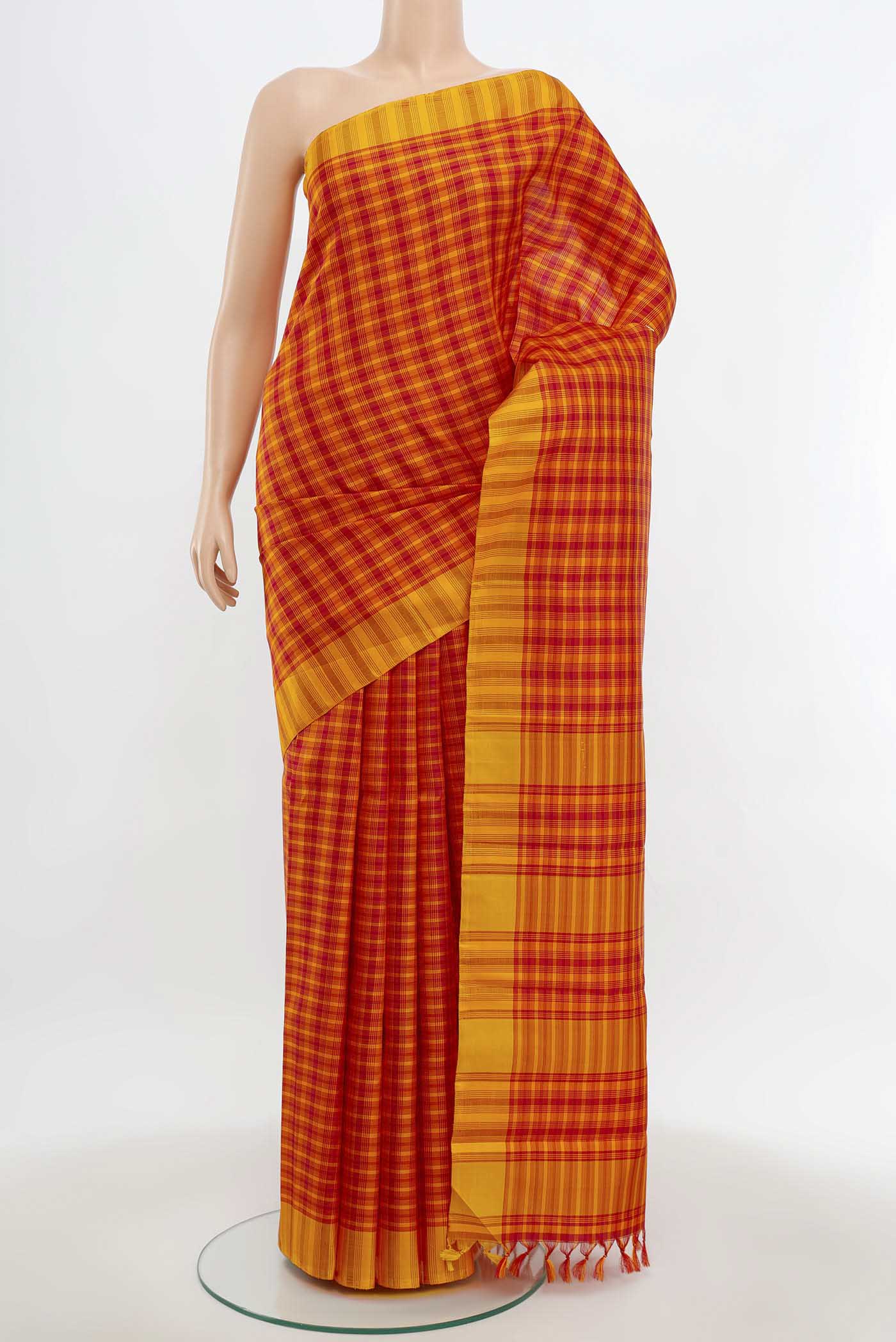 Maroon Kanchipuram Silk Saree with Zari Butta on the body and Silk Border.  displayed on a mannequin