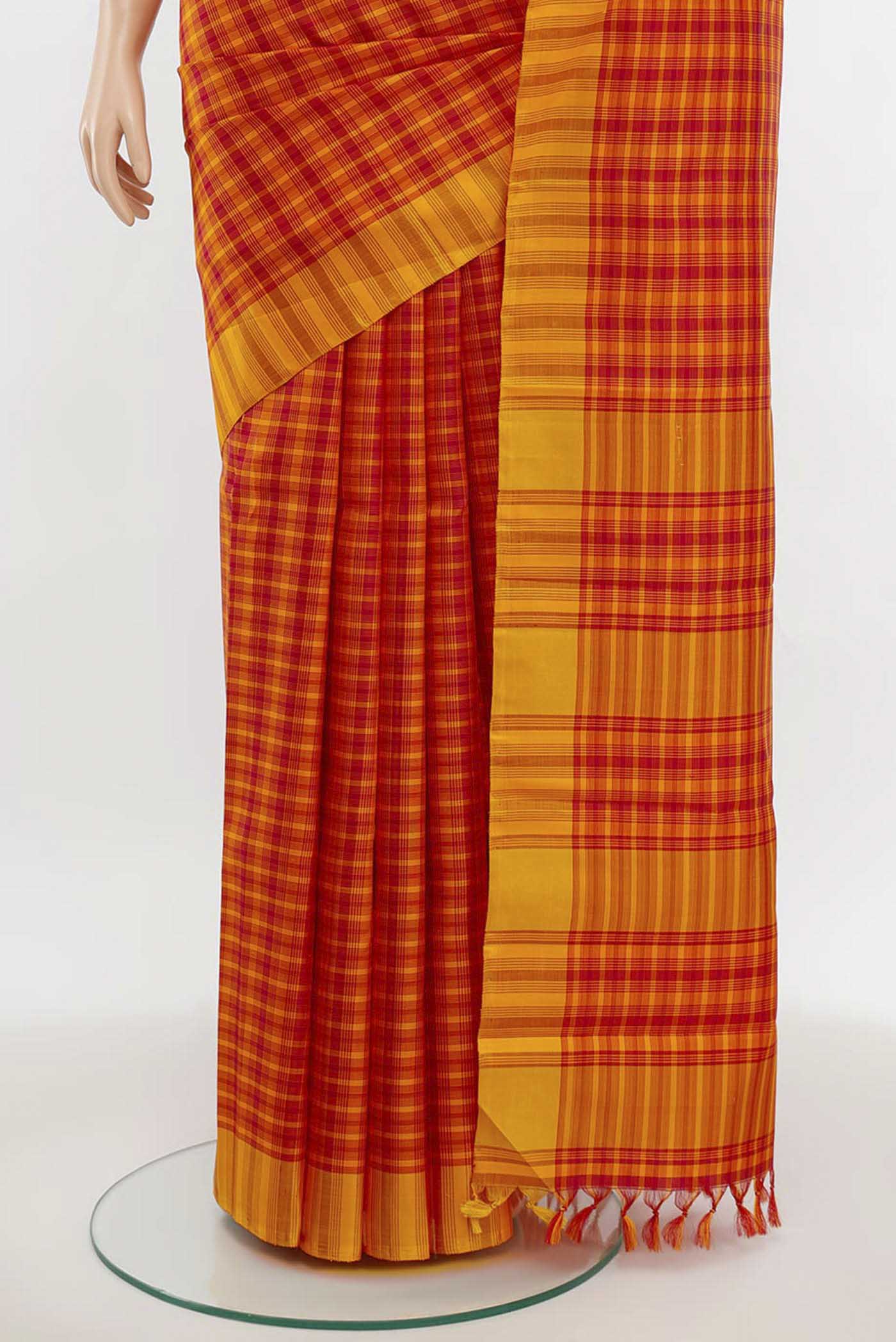 Pleats and pallu of Maroon Kanchipuram Silk Saree with Zari Butta on the body and Silk Border. 