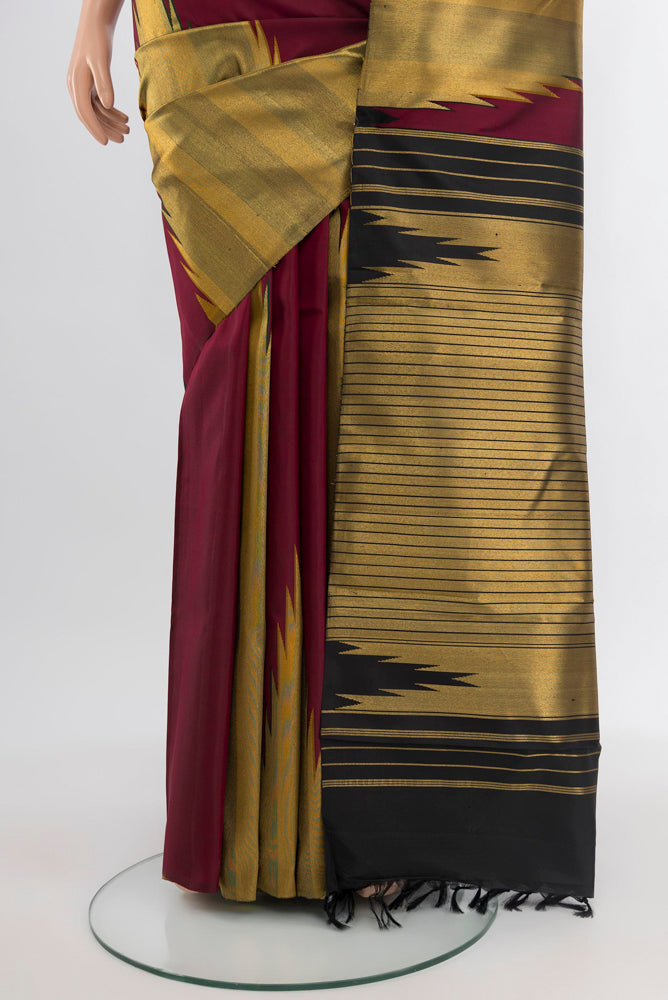 Pleats and pallu of Maroon Kanjivaram Silk Saree with Zari Butta on the body and Silk Border. 
