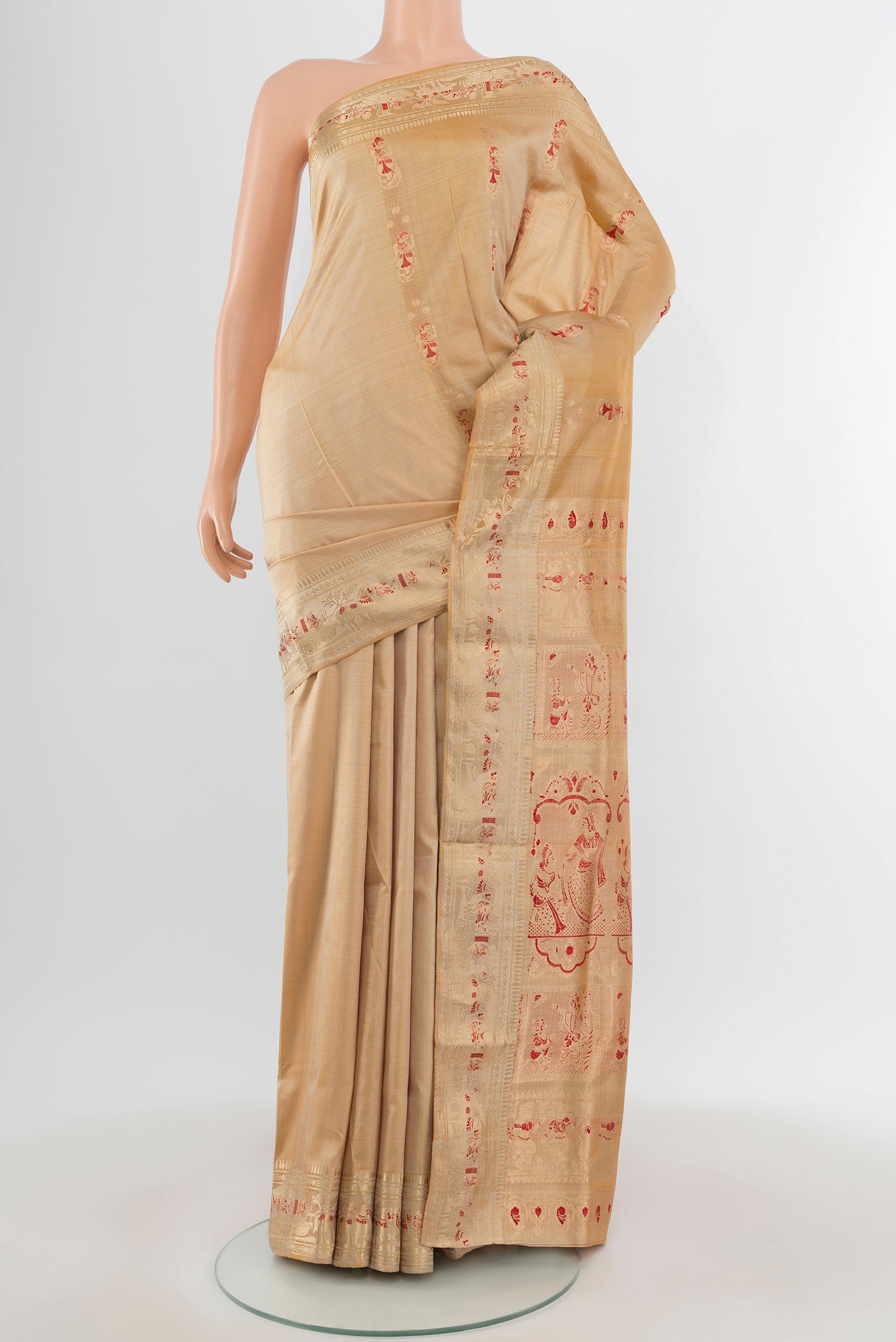 Beige Baluchari Silk Saree with Zari And Thread Butta on the body and Zari Border.  displayed on a mannequin