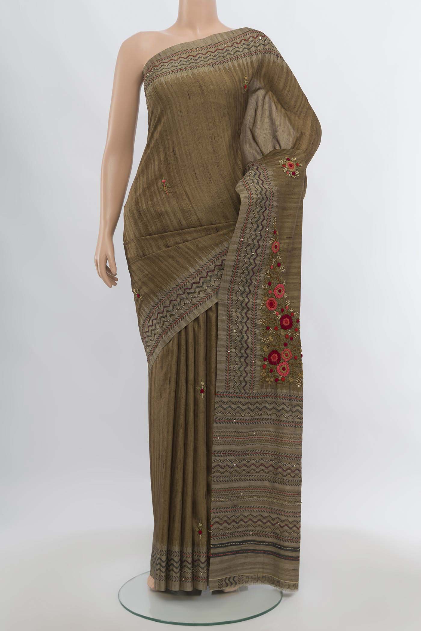 Brown Art Silk Saree with Zari Butta on the body and Zari Border.  displayed on a mannequin