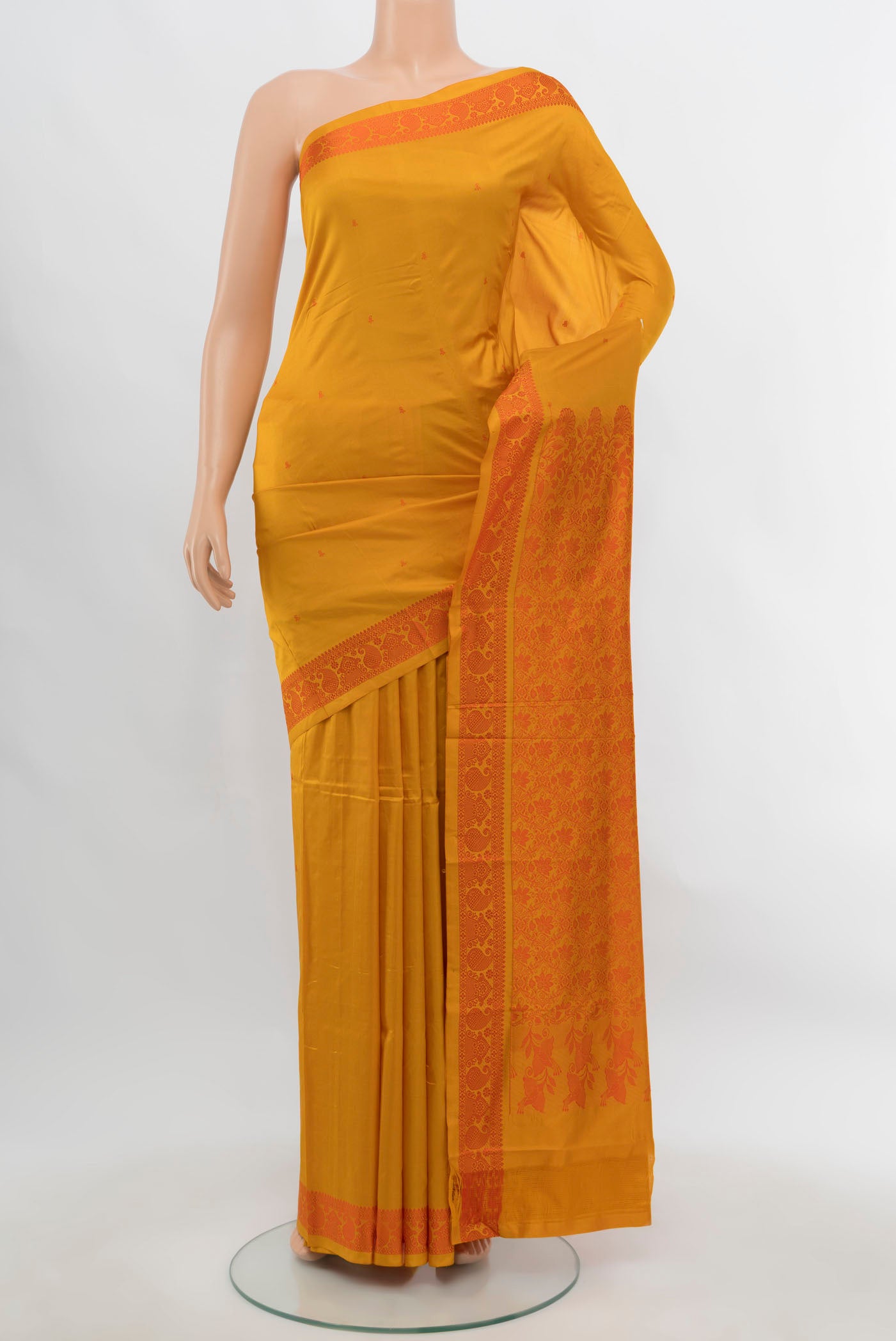 Yellow Kanjivaram Silk Saree with Zari Butta on the body and Silk Border.  displayed on a mannequin