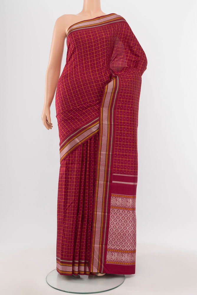 Maroon Kanjivaram Silk Saree with Zari Butta on the body and Silk Border.  displayed on a mannequin
