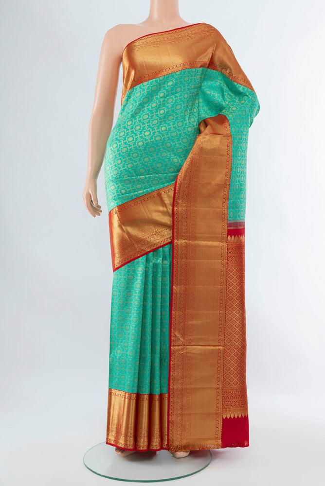 Sky Blue Kanjivaram Silk Saree with Zari Butta on the body and Silk Border.  displayed on a mannequin