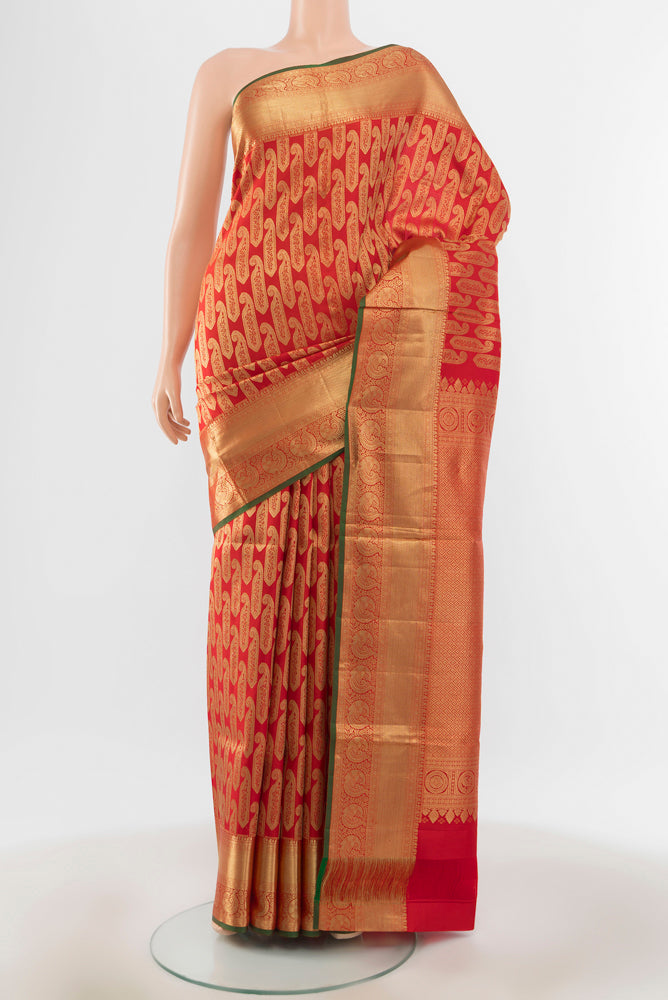 Red Kanchipuram Silk Saree with Zari Butta on the body and Silk Border.  displayed on a mannequin