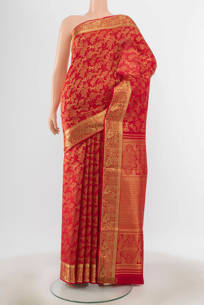 Red Kanchipuram Silk Saree with Zari Butta on the body and Silk Border.  displayed on a mannequin