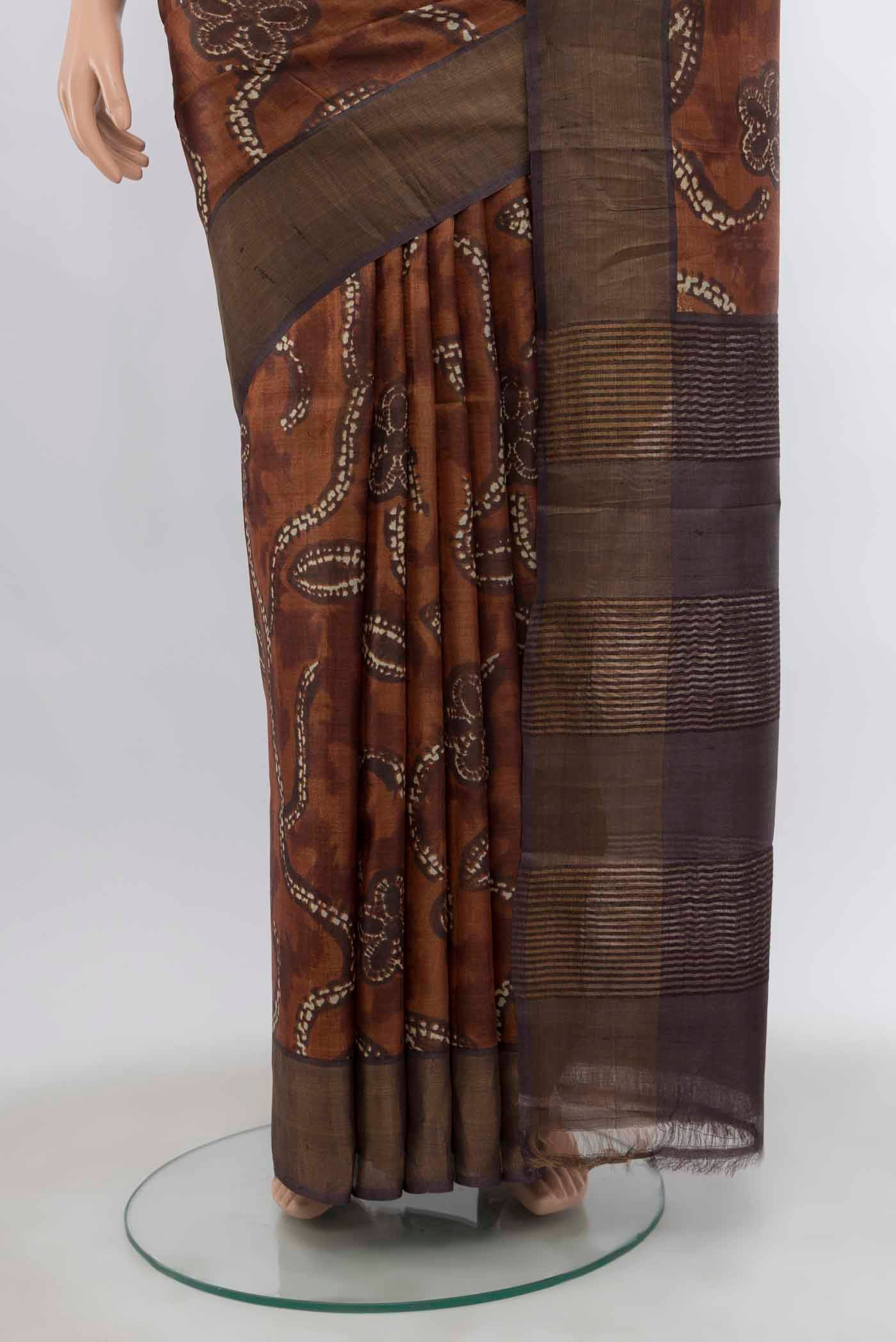 Pleats and pallu of Brown Tussar Silk Saree with Zari Butta on the body and Silk Border