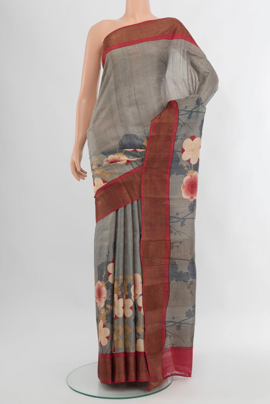 Grey Tussar Silk Saree with Floral Print on the body and Zari Border.  displayed on a mannequin