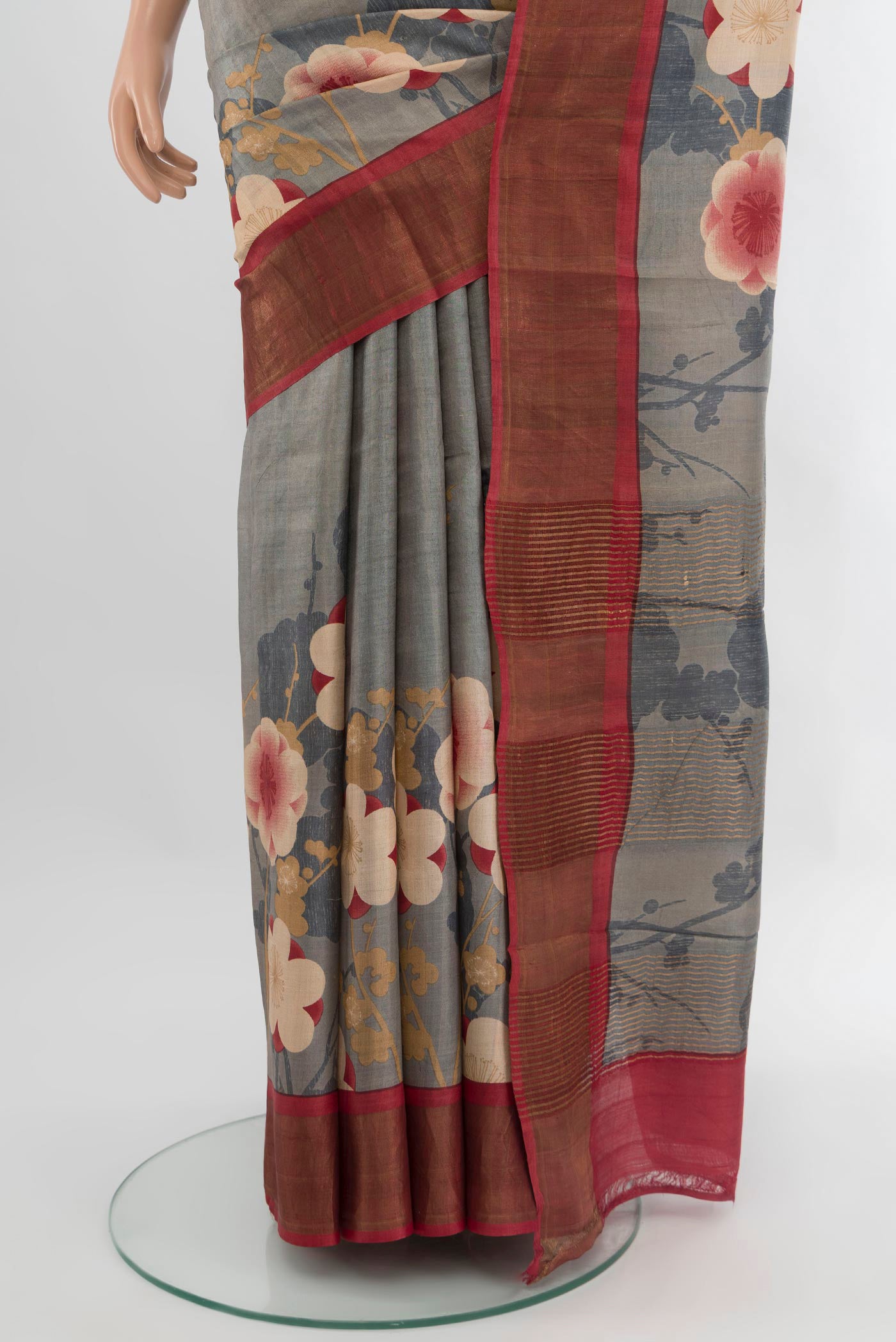 Pleats and pallu of Grey Tussar Silk Saree with Floral Print on the body and Zari Border. 