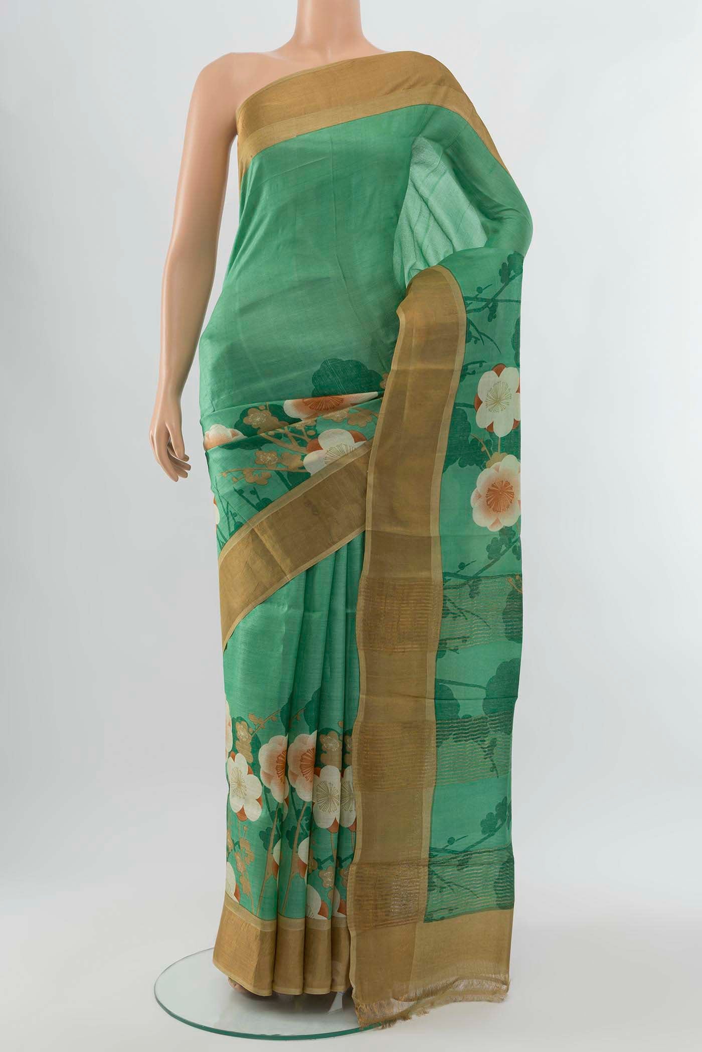 Light Green Tussar Silk Saree with Zari Butta on the body and Silk Border displayed on a mannequin