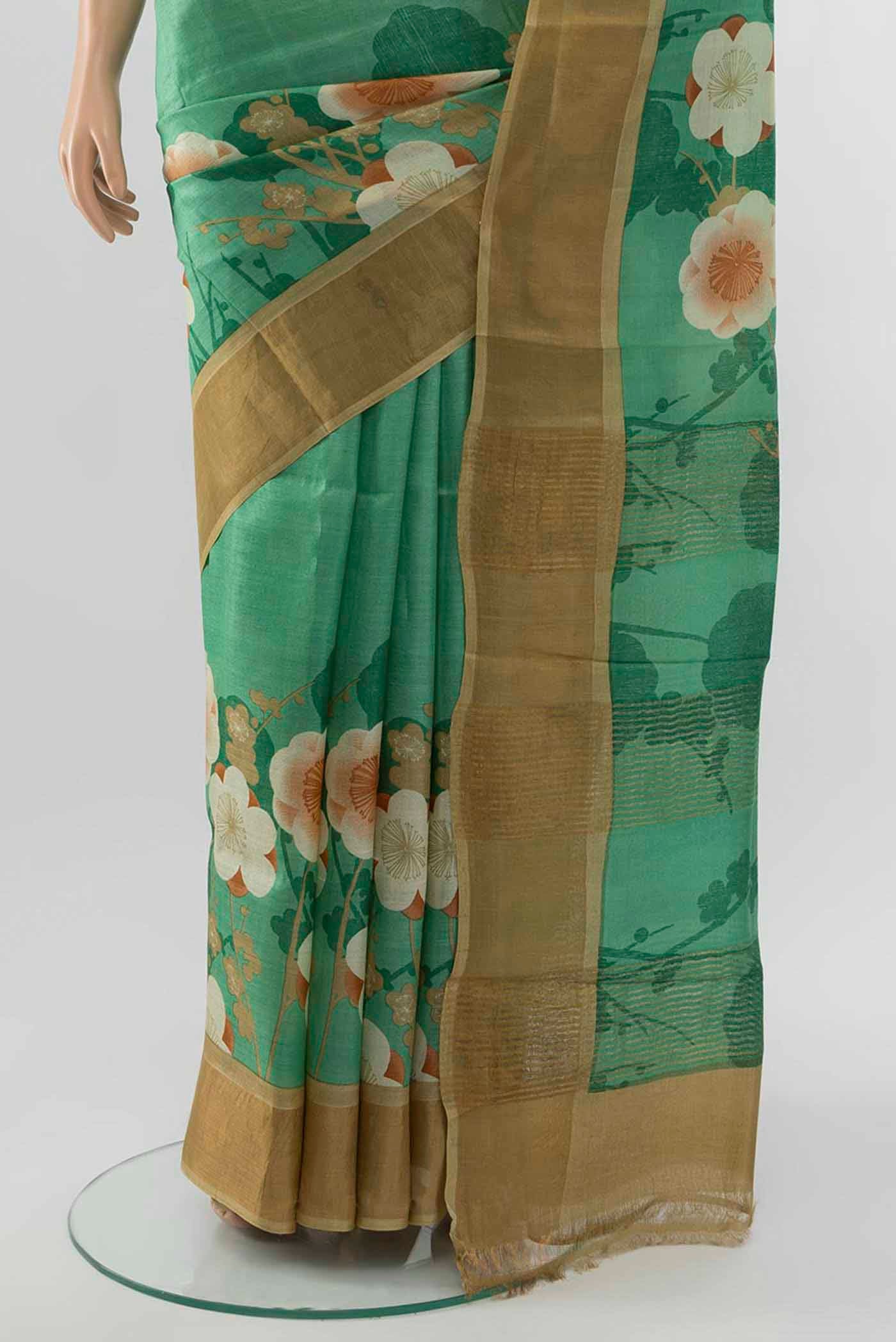 Pleats and pallu of Light Green Tussar Silk Saree with Zari Butta on the body and Silk Border
