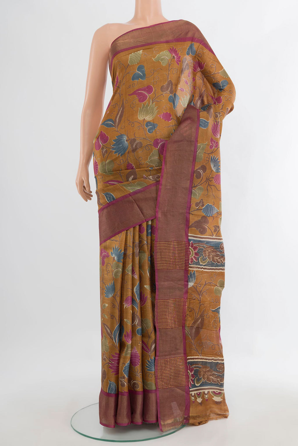 Mustard Tussar Saree with Floral Print on the body and Zari Border.  displayed on a mannequin