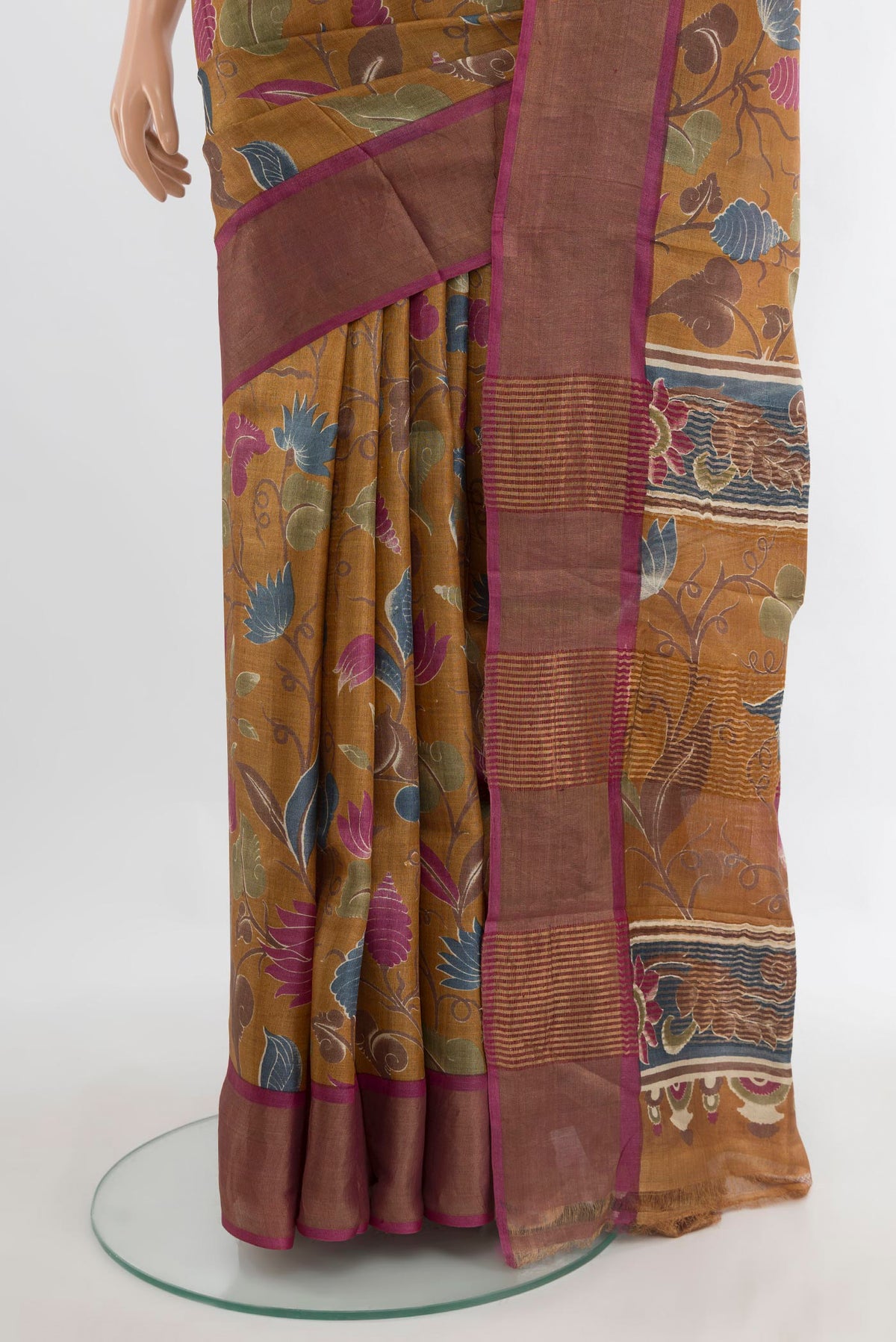 Pleats and pallu of Mustard Tussar Saree with Floral Print on the body and Zari Border. 