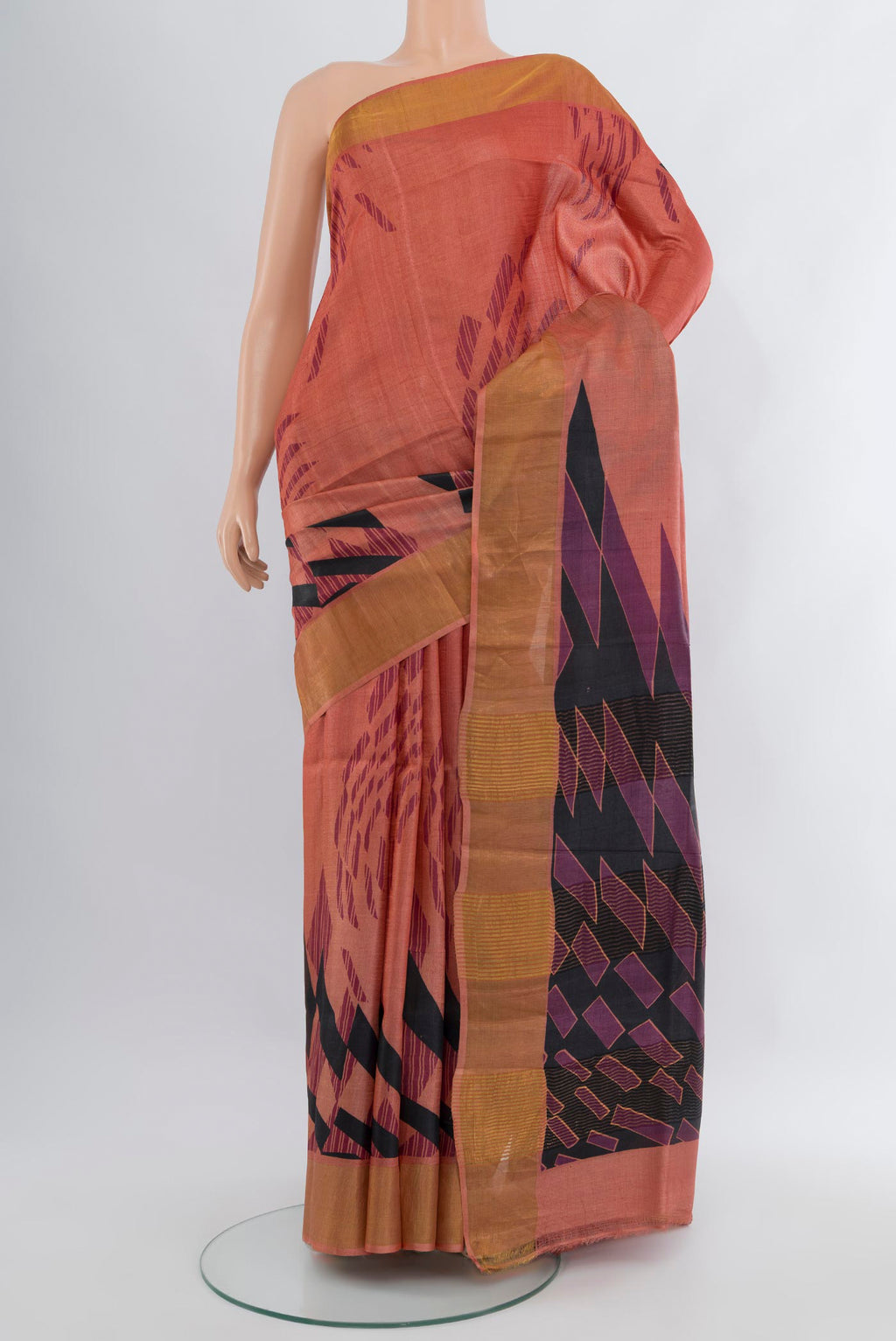 Coral Tussar Silk Saree with Printed design on the body and Zari Border.  displayed on a mannequin
