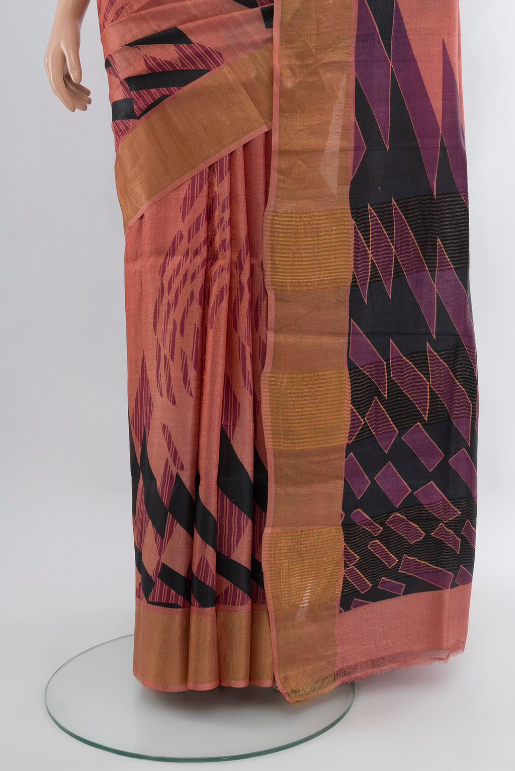 Pleats and pallu of Coral Tussar Silk Saree with Printed design on the body and Zari Border. 