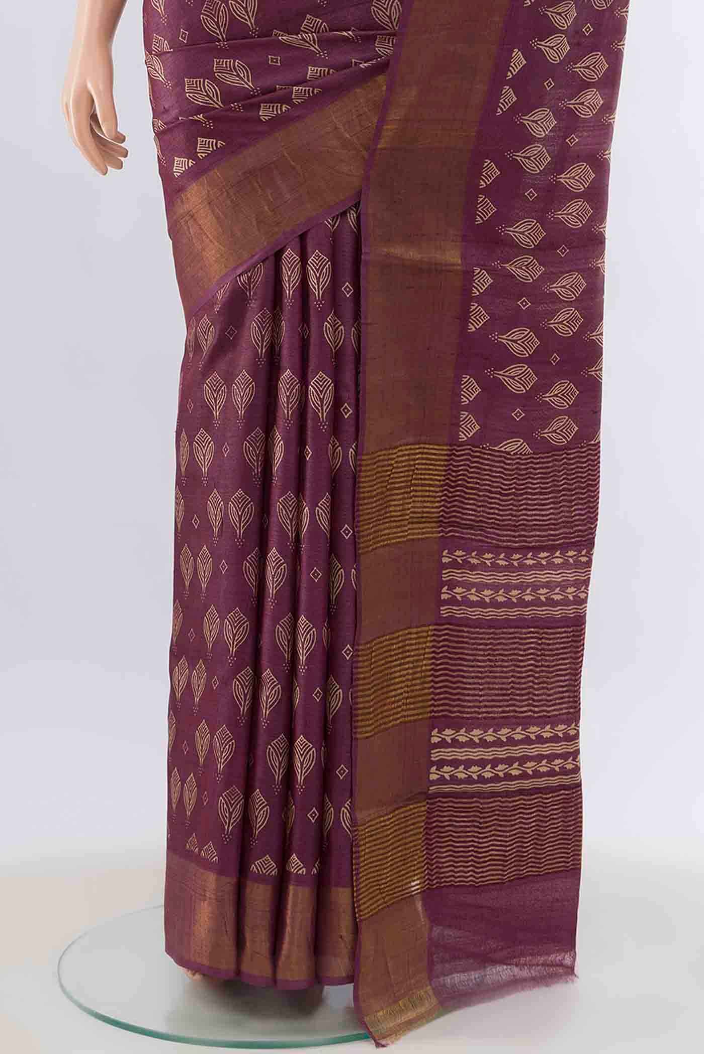Pleats and pallu of Magenta Tussar Silk Saree with Printed design on the body and Zari Border