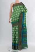 Pista Green Tussar Silk Saree with Floral Print on the body and Zari Border.  displayed on a mannequin