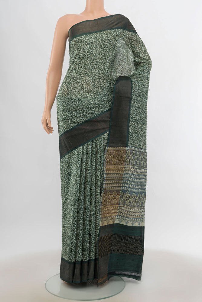 Light Green Tussar Silk Saree with Zari Butta on the body and Silk Border.  displayed on a mannequin