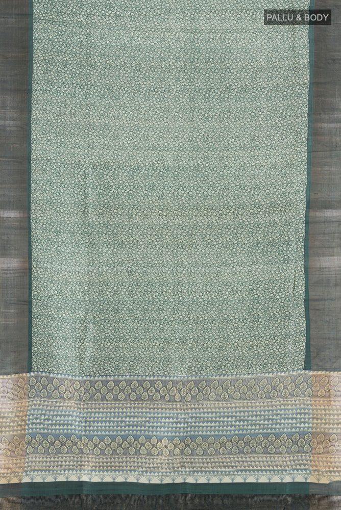 Flat view of Light Green Tussar Silk Saree with Zari Butta on the body and Silk Border. 