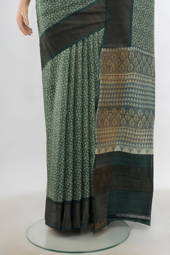 Pleats and pallu of Light Green Tussar Silk Saree with Zari Butta on the body and Silk Border. 