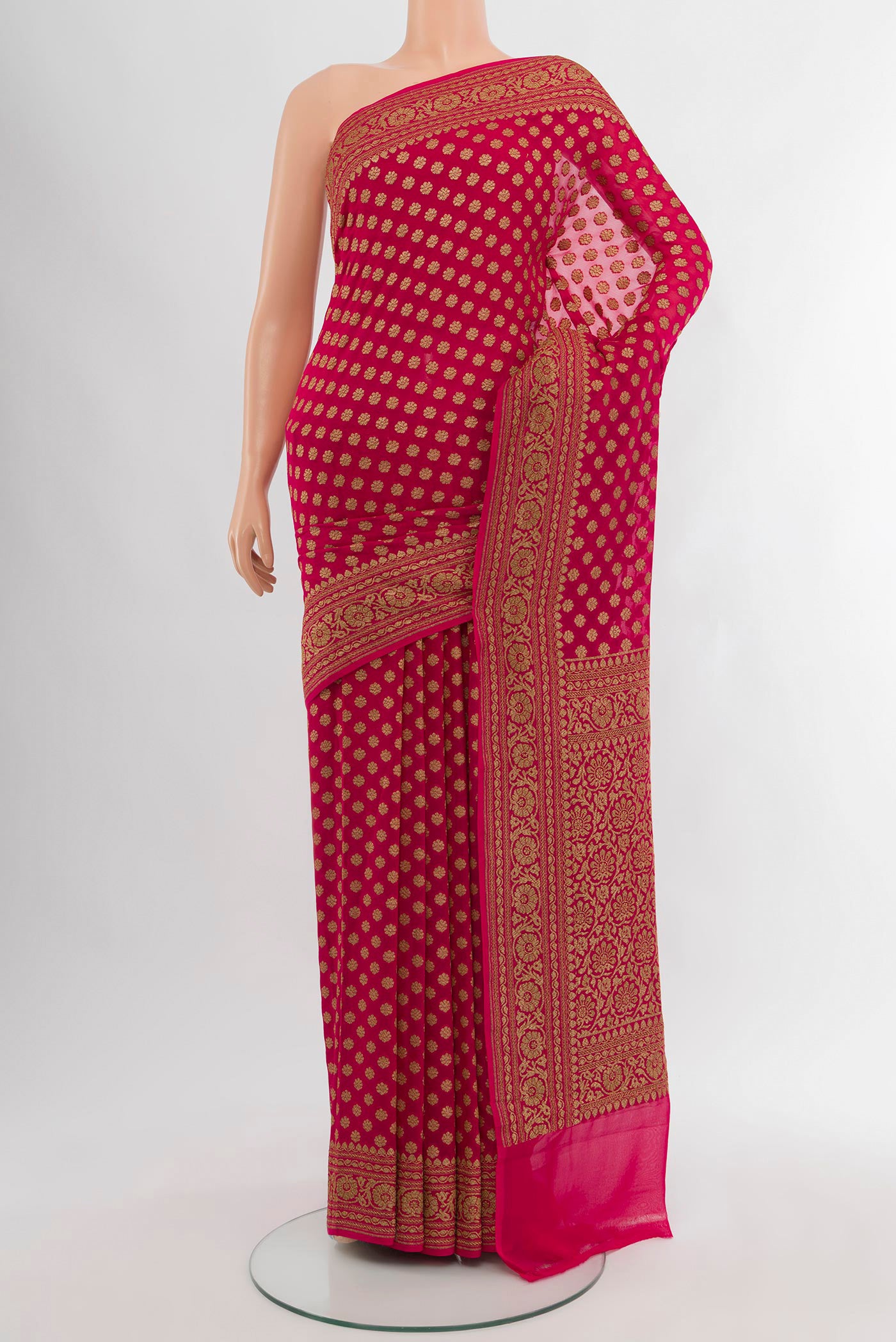 Dark Pink Banarasi Georgette Saree with Zari Butta on the body and Zari Border.  displayed on a mannequin