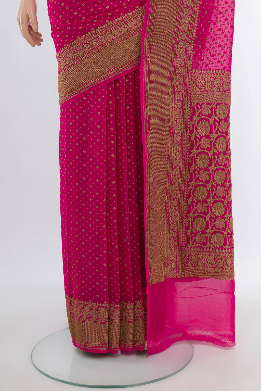 Pleats and pallu of Rani Pink Banarasi Georgette Saree with Zari Butta on the body and Silk Border. 
