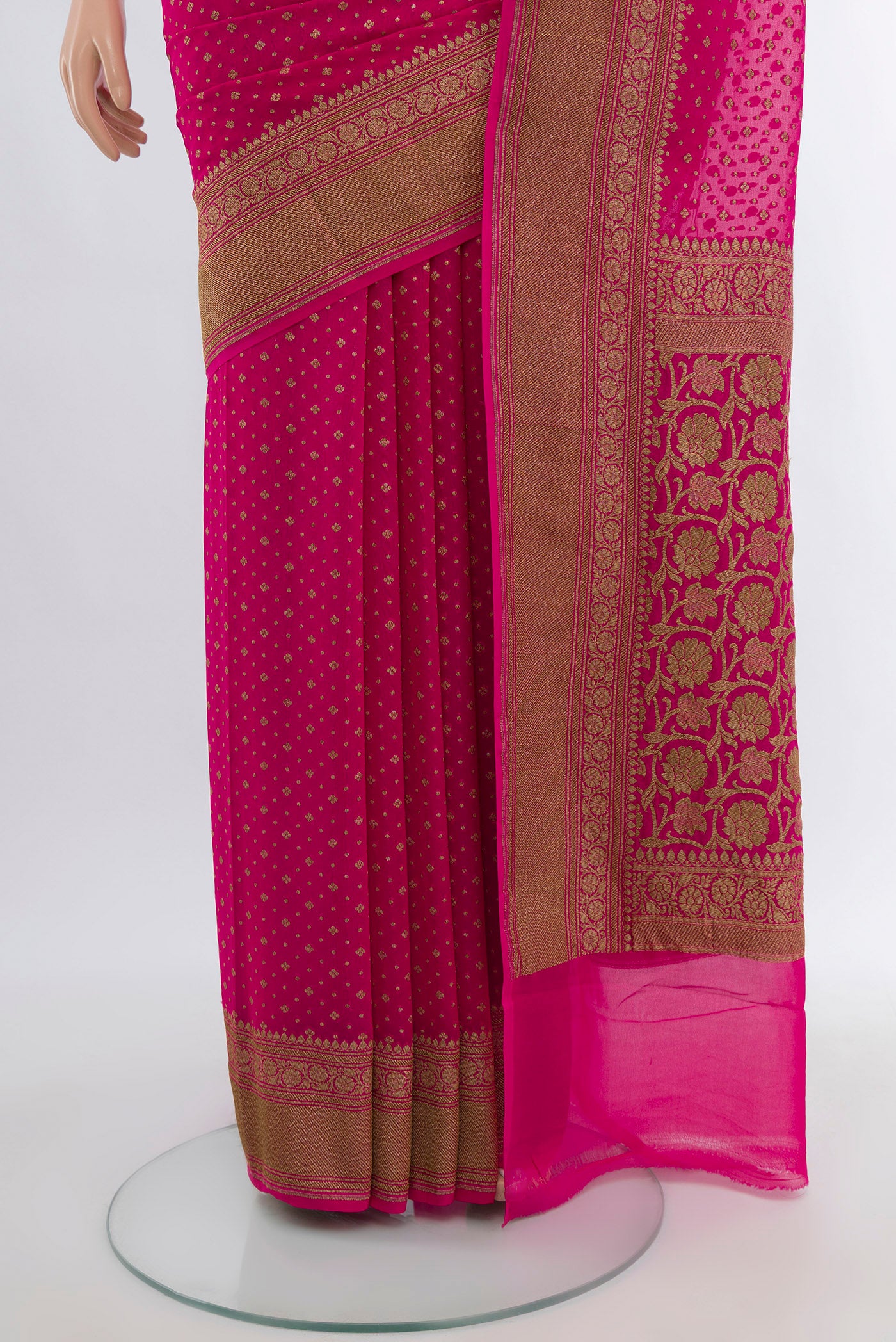 Pleats and pallu of Rani Pink Banarasi Georgette Saree with Zari Butta on the body and Silk Border. 