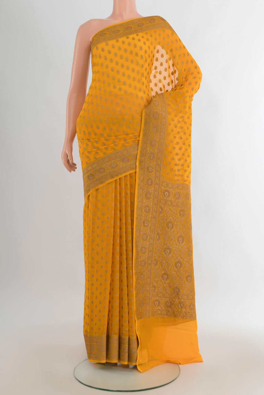 Yellow Banarasi Georgette Saree with Zari Brocade on the body and Zari Border.  displayed on a mannequin