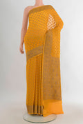Yellow Banarasi Georgette Saree with Zari Brocade on the body and Zari Border.  displayed on a mannequin
