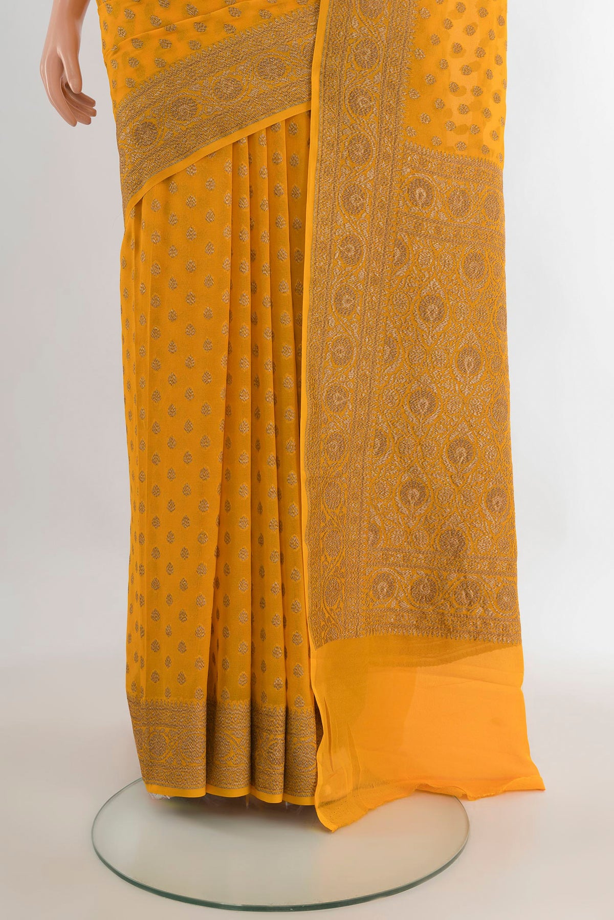 Pleats and pallu of Yellow Banarasi Georgette Saree with Zari Brocade on the body and Zari Border. 