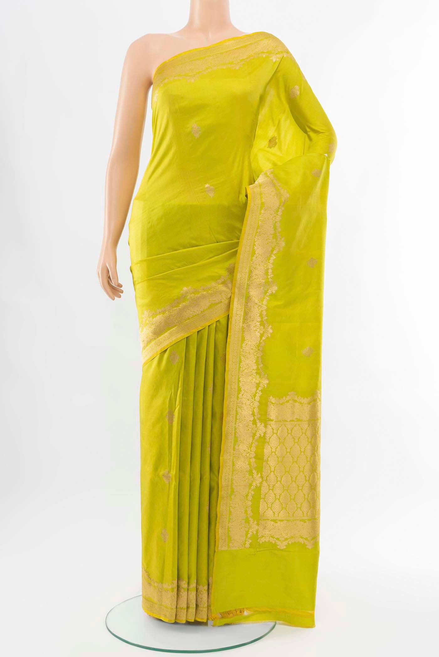 Pista Green Banarasi Katan Silk Saree with Zari Butta on the body and Silk Border displayed on a mannequin