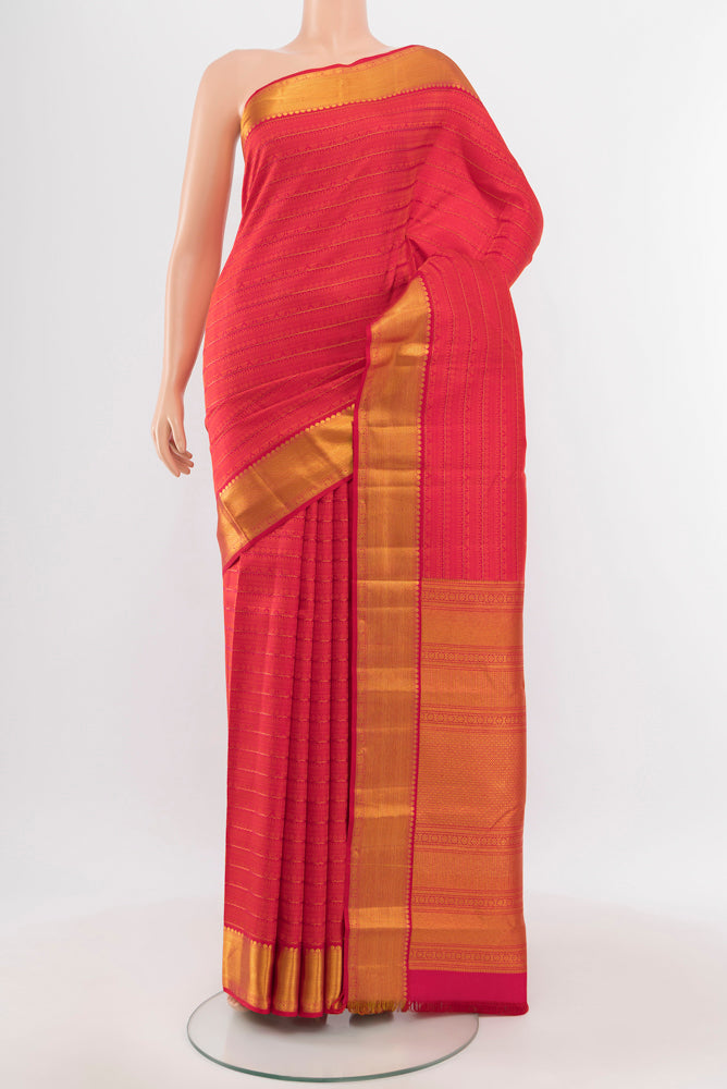 Peach Kanchipuram Silk Saree with Zari Butta on the body and Silk Border.  displayed on a mannequin