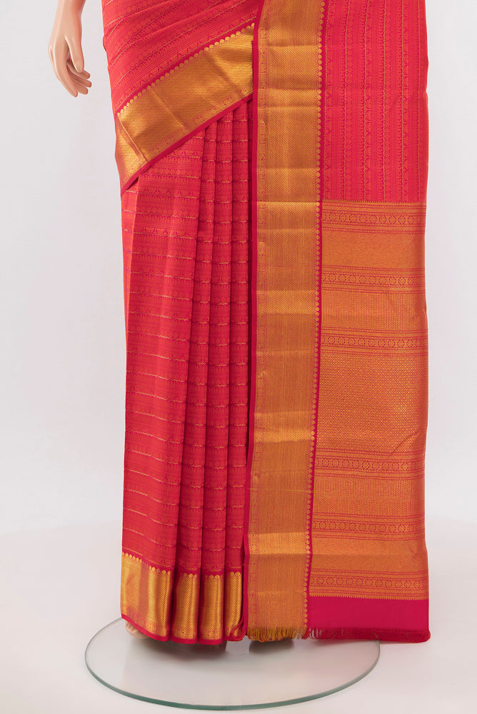 Pleats and pallu of Peach Kanchipuram Silk Saree with Zari Butta on the body and Silk Border. 