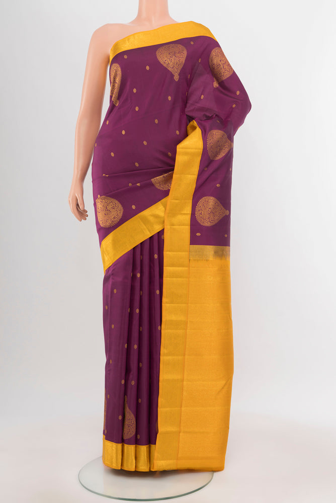 Purple Kanchipuram Silk Saree with Zari Butta on the body and Silk Border.  displayed on a mannequin