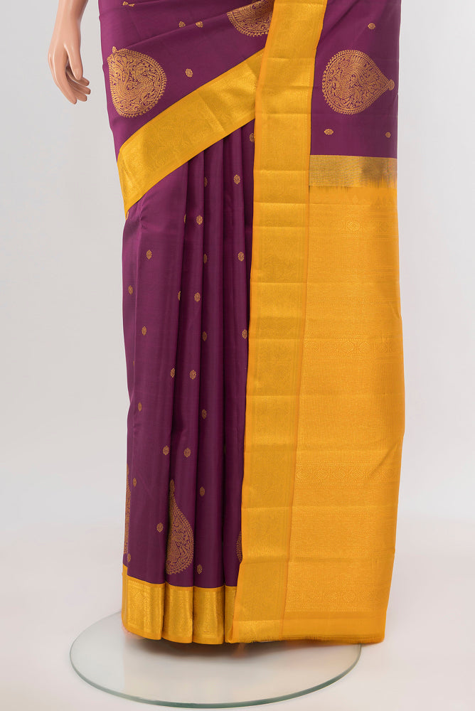 Pleats and pallu of Purple Kanchipuram Silk Saree with Zari Butta on the body and Silk Border. 
