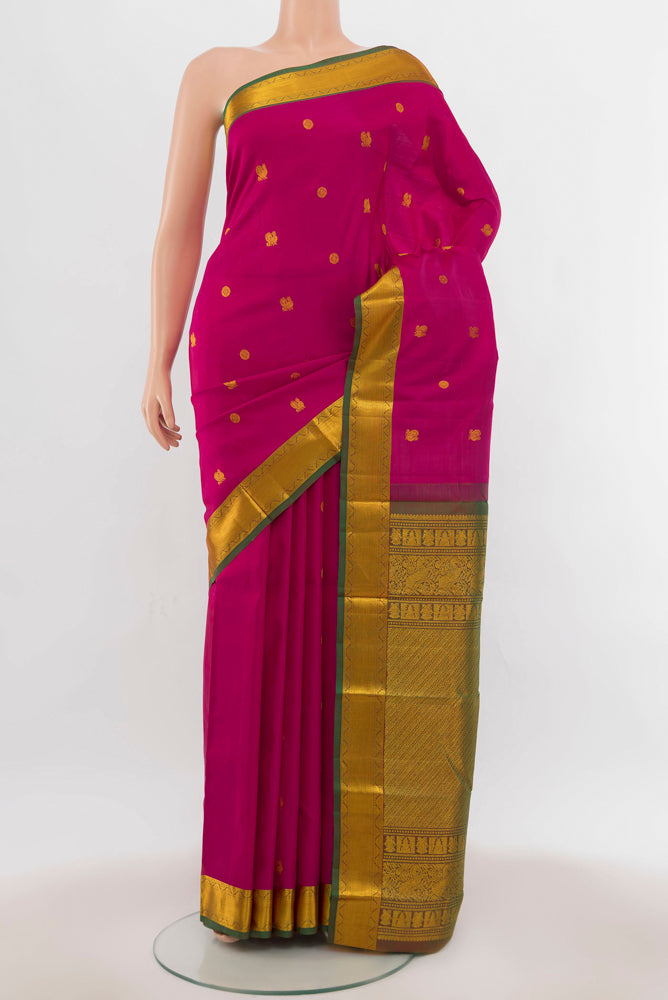 Dark Pink Kanchipuram Silk Saree with Zari Butta on the body and Silk Border.  displayed on a mannequin
