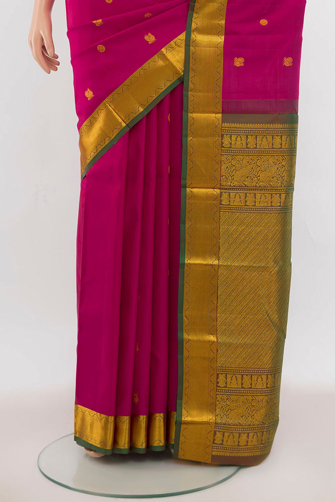 Pleats and pallu of Dark Pink Kanchipuram Silk Saree with Zari Butta on the body and Silk Border. 