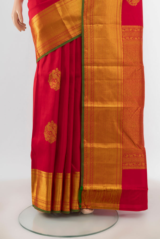 Pleats and pallu of Red Kanjivaram Silk Saree with Zari Butta on the body and Silk Border. 