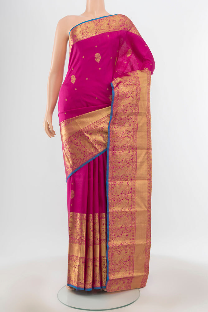 Pure Silk Pure Zari Magenta Kanjivaram Saree with Zari Butta on the body and Silk Border.  displayed on a mannequin