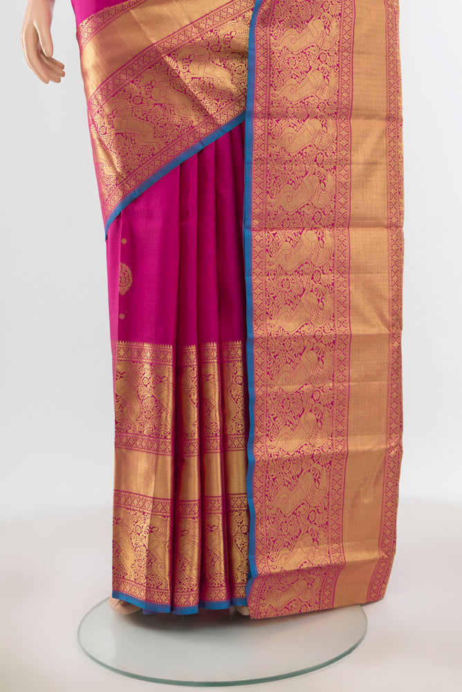 Pleats and pallu of Pure Silk Pure Zari Magenta Kanjivaram Saree with Zari Butta on the body and Silk Border. 