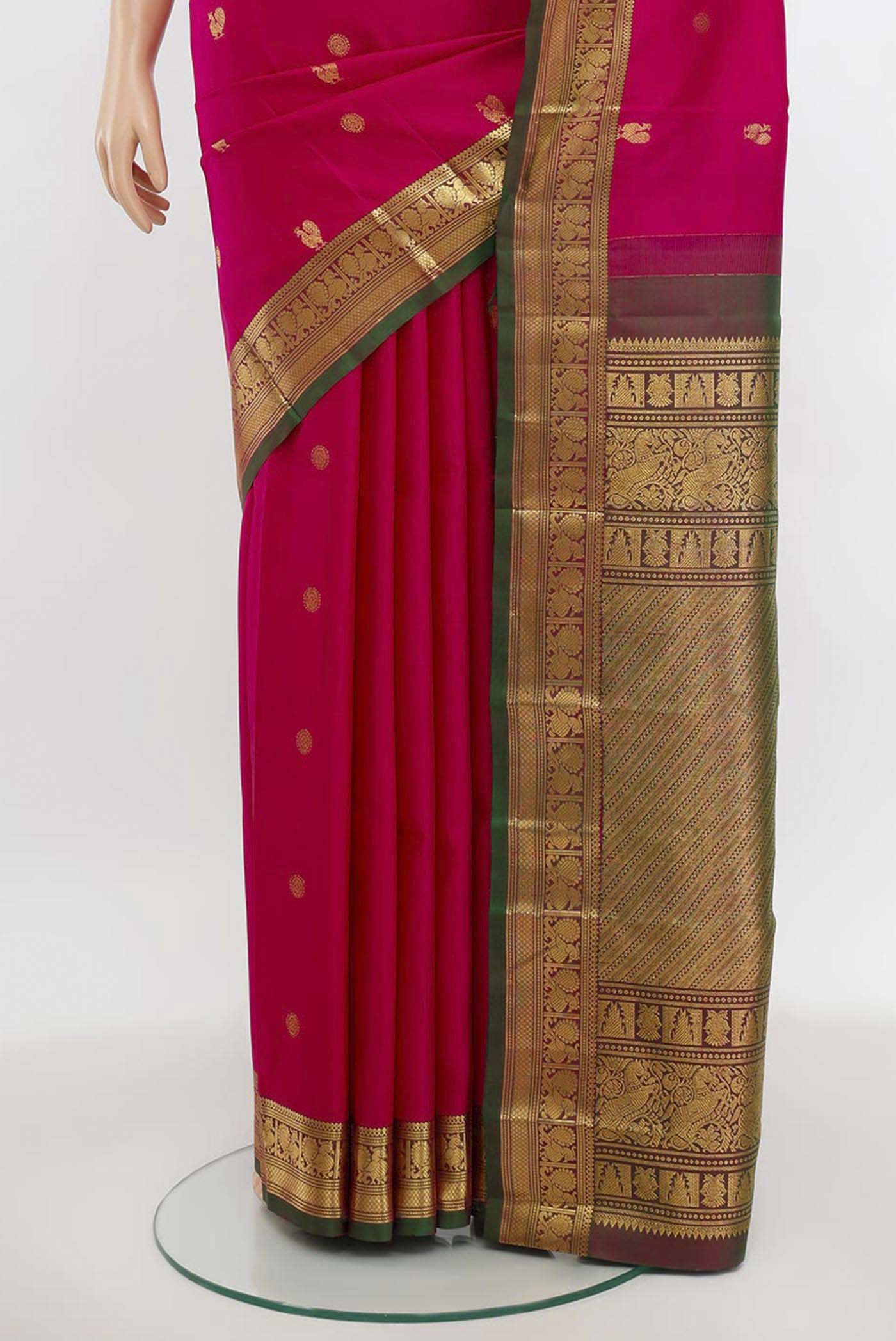 Pleats and pallu of Magenta Kanchipuram Silk Saree with Zari Butta on the body and Silk Border. 