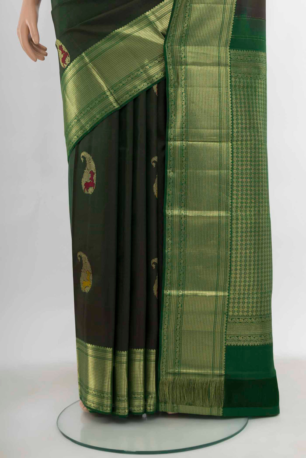 Pleats and pallu of Bottle Green Kanjivaram Silk Saree with Zari Butta on the body and Silk Border. 