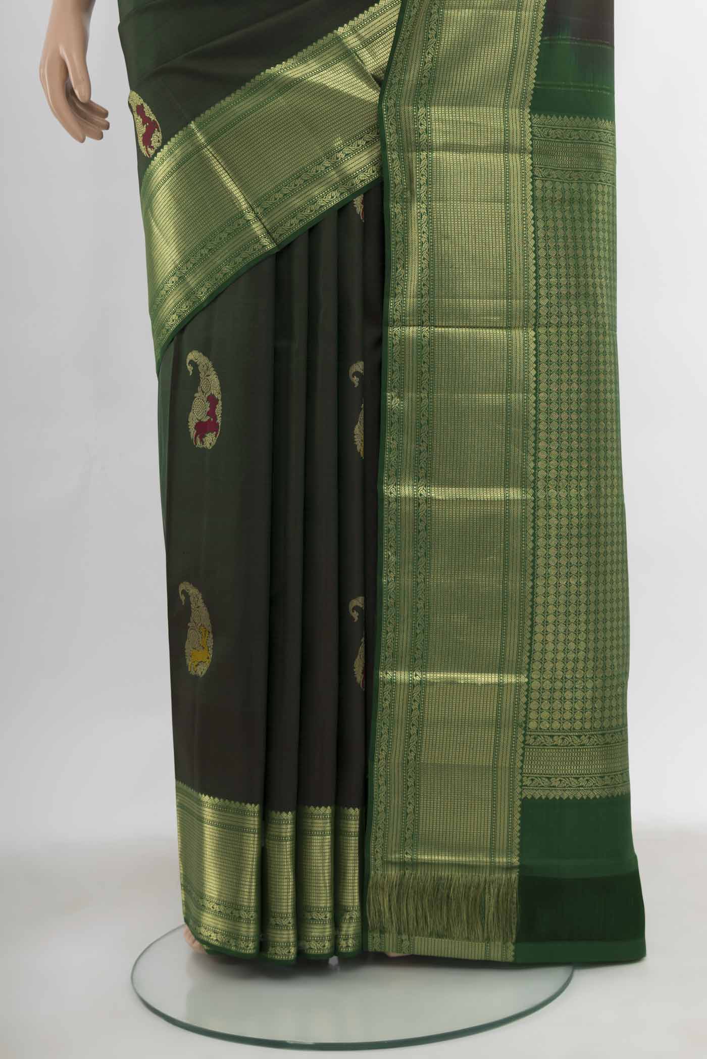 Pleats and pallu of Bottle Green Kanjivaram Silk Saree with Zari Butta on the body and Silk Border. 