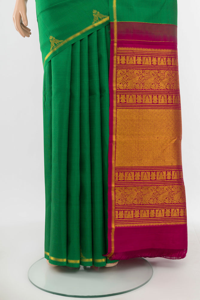 Pleats and pallu of Pure Silk Pure Zari Light Green Kanchipuram Saree with Zari Butta on the body and Silk Border. 